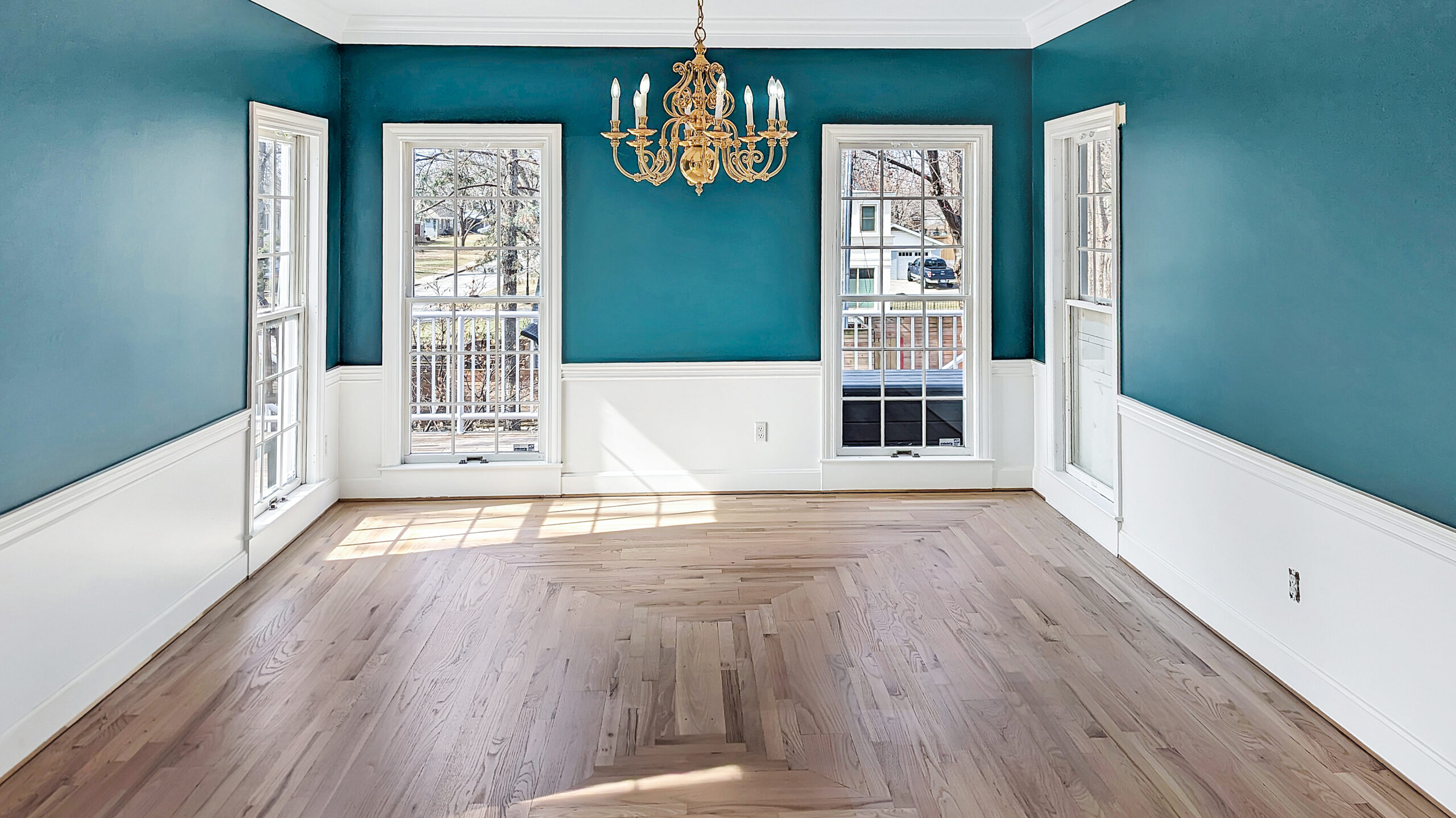 Completed natural hardwood flooring after green carpet removal in Westwood KS