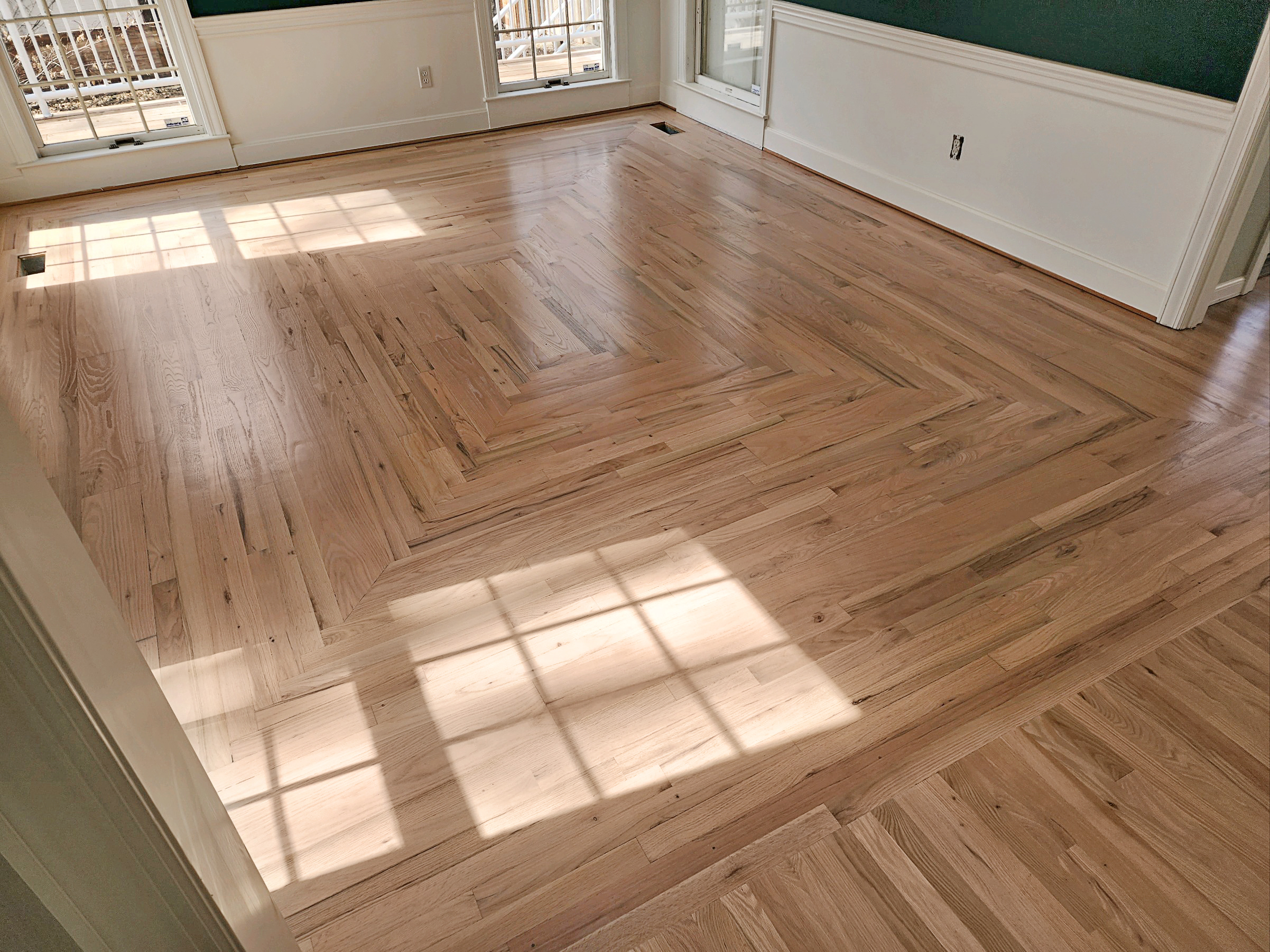 Final coat of polyurethane being applied to hardwood floors
