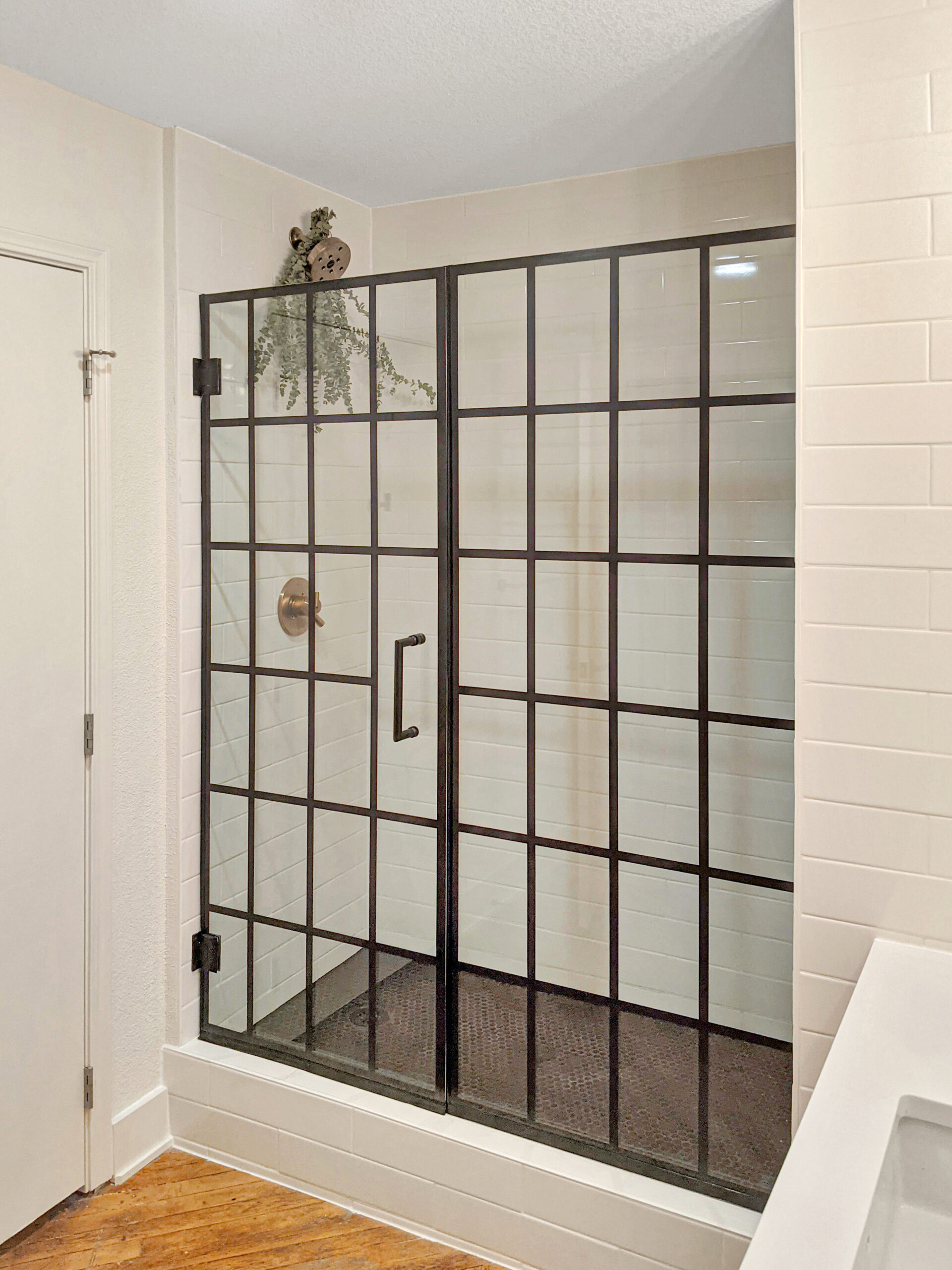 Subway tile walls with black mosaic shower pan detail